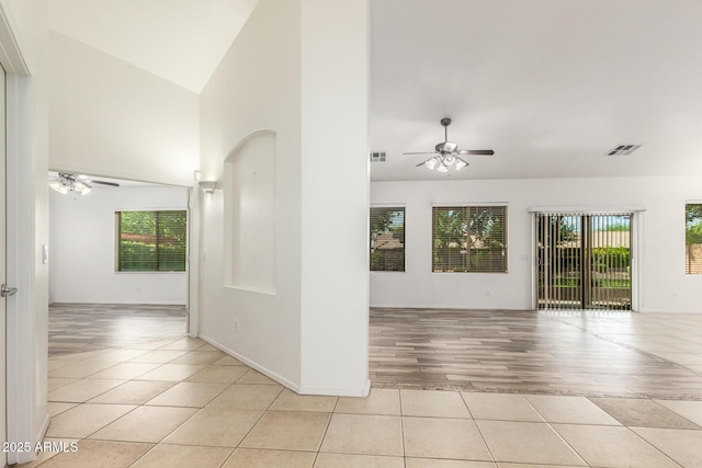 unfurnished room featuring ceiling fan, high vaulted ceiling, and light tile patterned floors