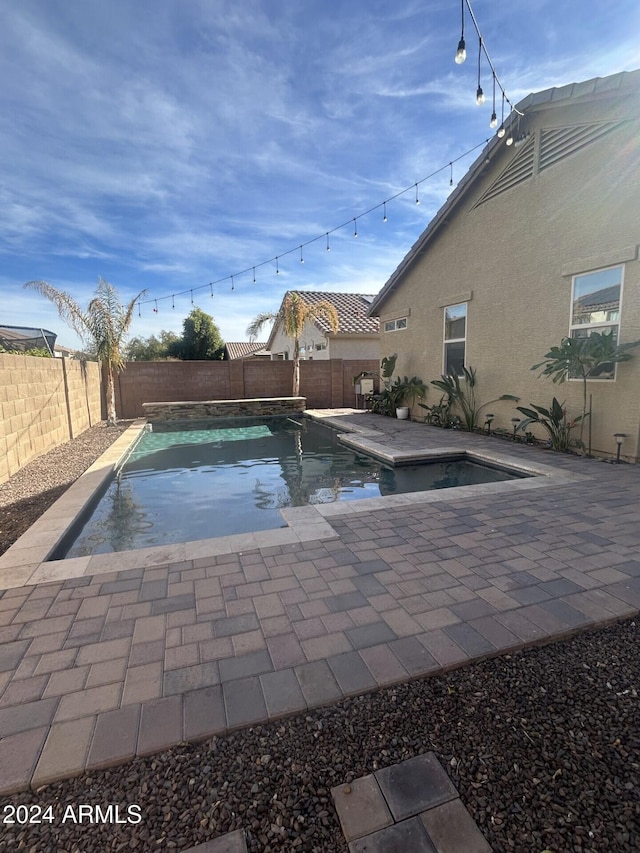 view of swimming pool featuring a hot tub