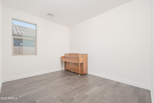 empty room with hardwood / wood-style flooring