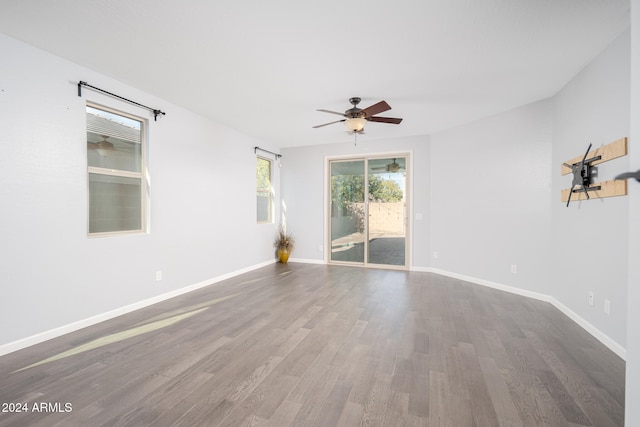 spare room featuring ceiling fan and hardwood / wood-style flooring