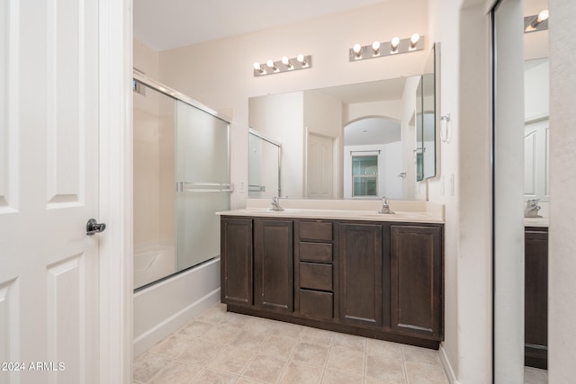 bathroom featuring shower / bath combination with glass door and vanity