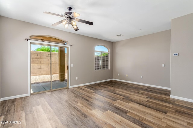 empty room with ceiling fan and wood-type flooring