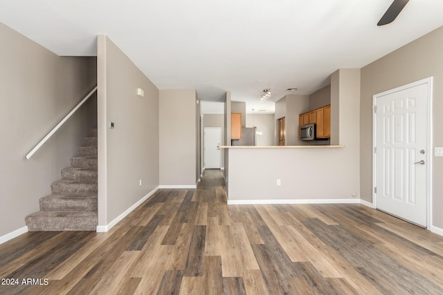 interior space with ceiling fan and dark wood-type flooring