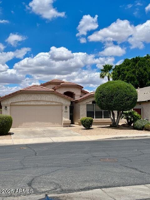 6376 W Adobe Dr, Glendale, AZ 85308 - view of front facade with a garage, stucco siding, concrete driveway, and a tiled roof
