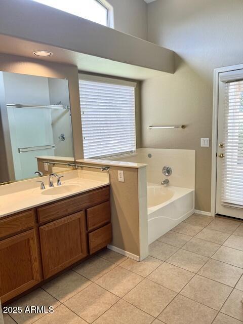 6376 W Adobe Dr, Glendale, AZ 85308 - full bath with tile patterned flooring, vanity, plenty of natural light, and a garden tub