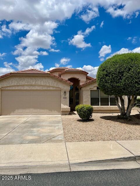 6376 W Adobe Dr, Glendale, AZ 85308 - view of front of property featuring a garage, stucco siding, driveway, and a tiled roof