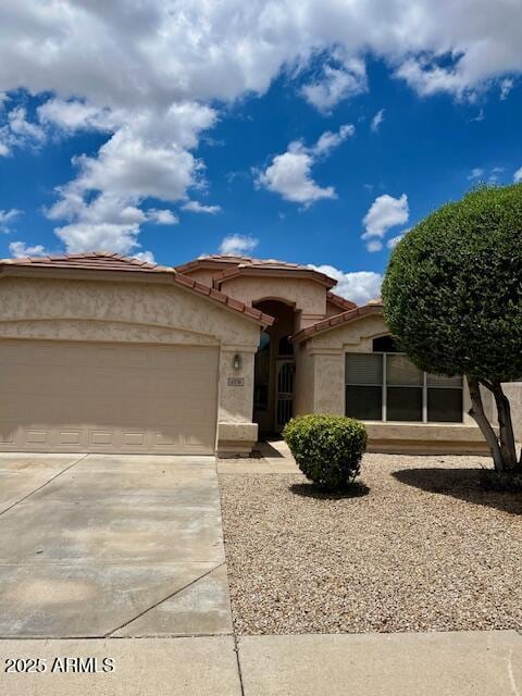 6376 W Adobe Dr, Glendale, AZ 85308 - view of front of home featuring concrete driveway, stucco siding, an attached garage, and a tile roof