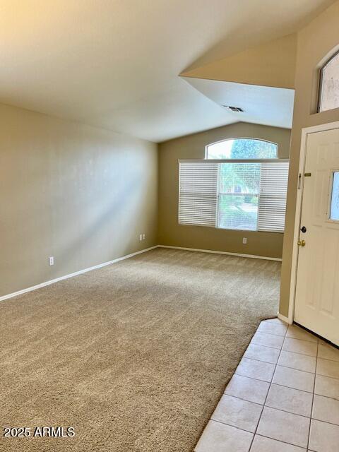 6376 W Adobe Dr, Glendale, AZ 85308 - entryway with light colored carpet, lofted ceiling, baseboards, and light tile patterned floors