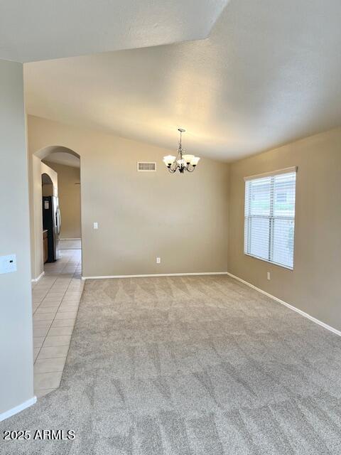 6376 W Adobe Dr, Glendale, AZ 85308 - empty room with arched walkways, light colored carpet, a chandelier, baseboards, and lofted ceiling