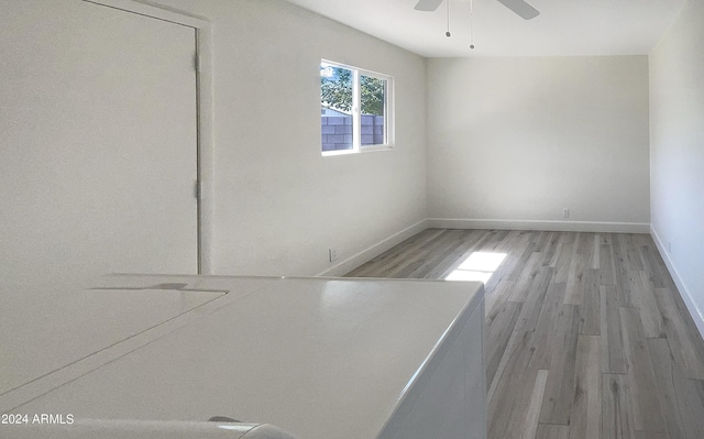 empty room with light wood-type flooring and ceiling fan