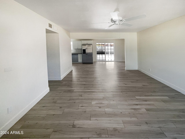 empty room with ceiling fan and hardwood / wood-style floors