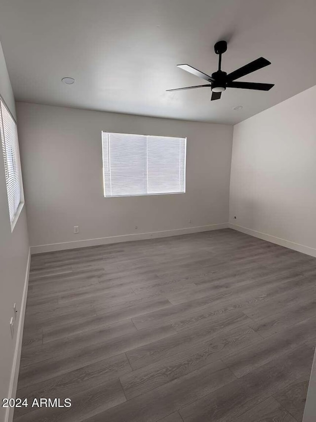 unfurnished room with hardwood / wood-style flooring and ceiling fan