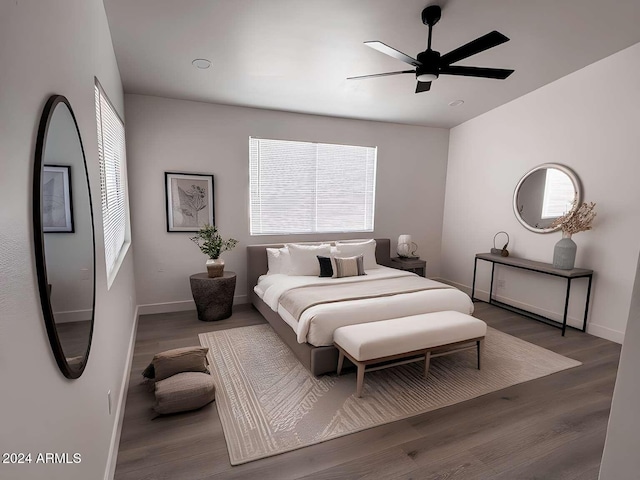 bedroom with ceiling fan and dark wood-type flooring