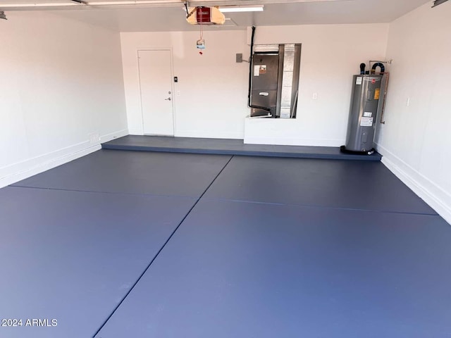 garage featuring electric water heater, a garage door opener, and heating unit