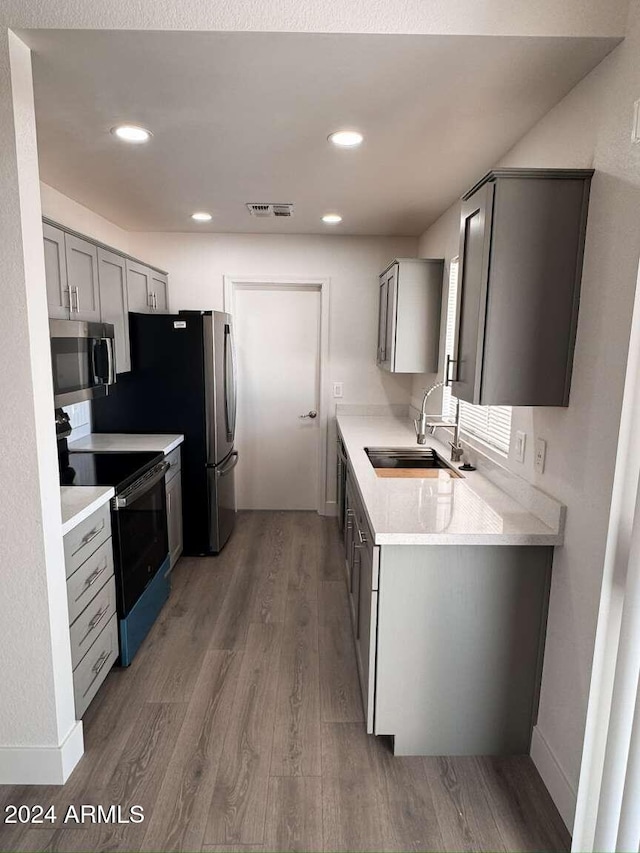 kitchen with dark hardwood / wood-style floors, gray cabinets, sink, and black electric range