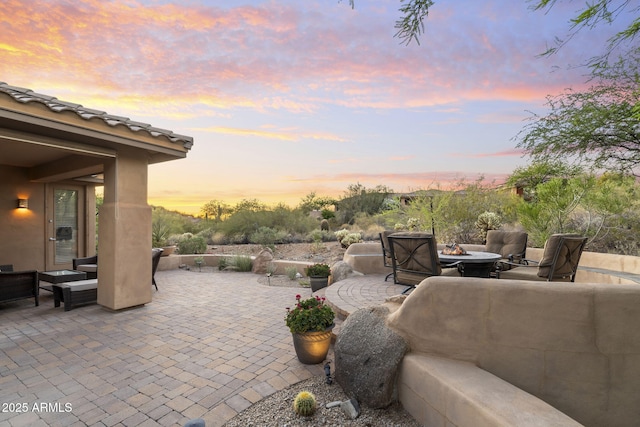 11400 E Helm Dr, Scottsdale, AZ 85255 - patio terrace at dusk featuring an outdoor living space with a fire pit