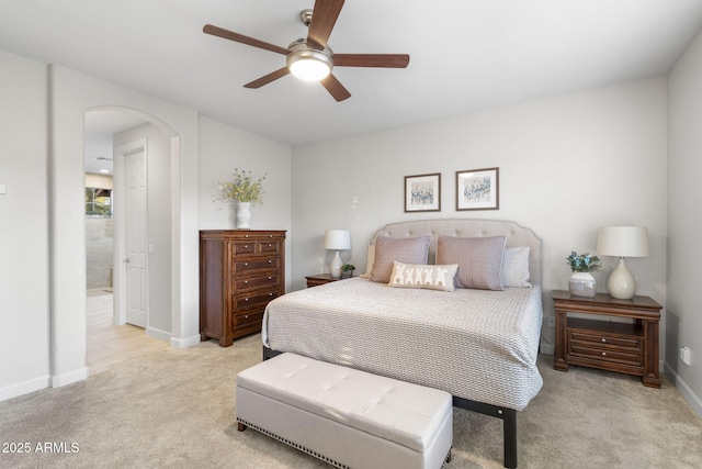 11400 E Helm Dr, Scottsdale, AZ 85255 - bedroom featuring arched walkways, light colored carpet, baseboards, and ceiling fan
