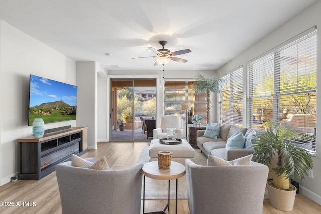 11400 E Helm Dr, Scottsdale, AZ 85255 - living room featuring ceiling fan, baseboards, and light wood-style floors