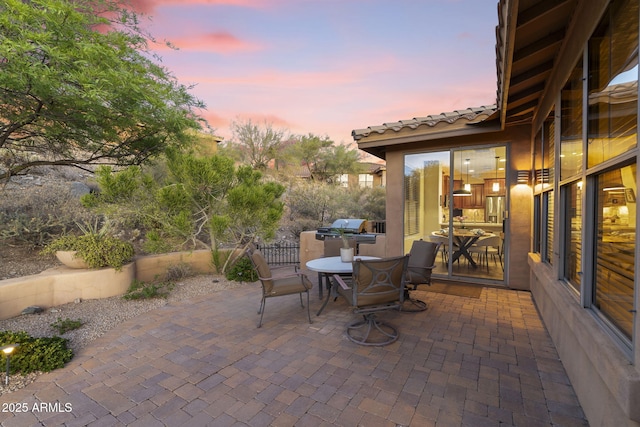 11400 E Helm Dr, Scottsdale, AZ 85255 - patio terrace at dusk with outdoor dining space