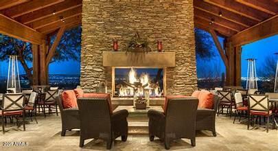 11400 E Helm Dr, Scottsdale, AZ 85255 - patio at twilight featuring an outdoor living space with a fireplace