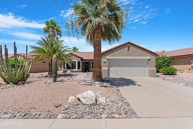15971 W Indigo Ln, Surprise, AZ 85374 - view of front of property with driveway, an attached garage, stucco siding, and a tile roof