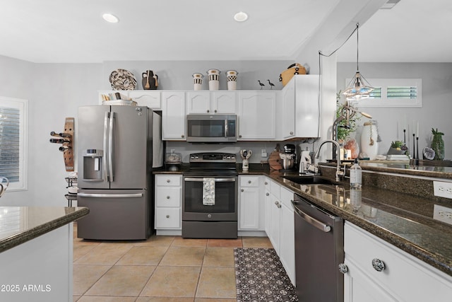 15971 W Indigo Ln, Surprise, AZ 85374 - kitchen with stainless steel appliances, white cabinets, light tile patterned floors, dark stone countertops, and recessed lighting