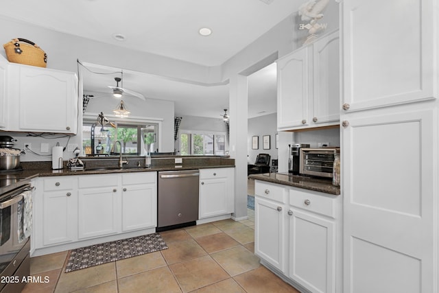 15971 W Indigo Ln, Surprise, AZ 85374 - kitchen featuring stainless steel appliances, white cabinetry, dark stone countertops, and light tile patterned floors