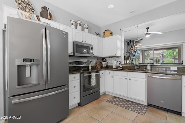 15971 W Indigo Ln, Surprise, AZ 85374 - kitchen featuring appliances with stainless steel finishes, white cabinetry, light tile patterned floors, and dark stone counters