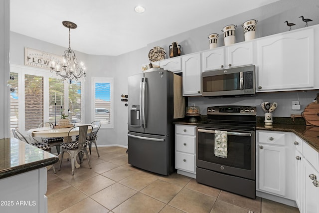 15971 W Indigo Ln, Surprise, AZ 85374 - kitchen featuring stainless steel appliances, white cabinets, light tile patterned floors, and a chandelier