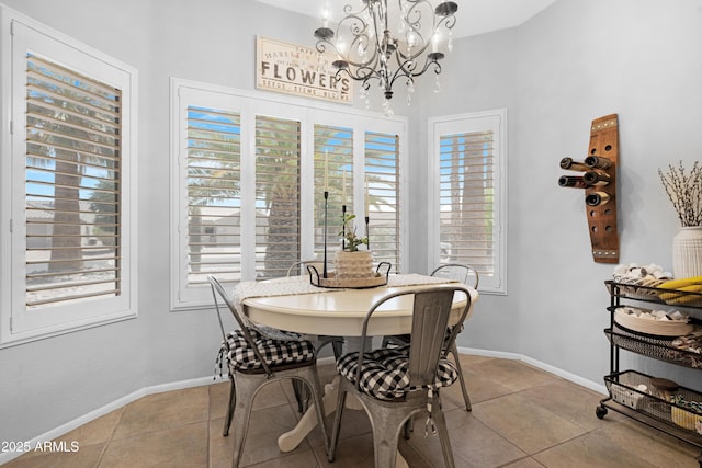 15971 W Indigo Ln, Surprise, AZ 85374 - dining room featuring a chandelier, light tile patterned floors, healthy amount of natural light, and a towering ceiling