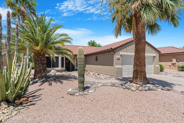 15971 W Indigo Ln, Surprise, AZ 85374 - view of front of home with a tiled roof, stucco siding, concrete driveway, and an attached garage