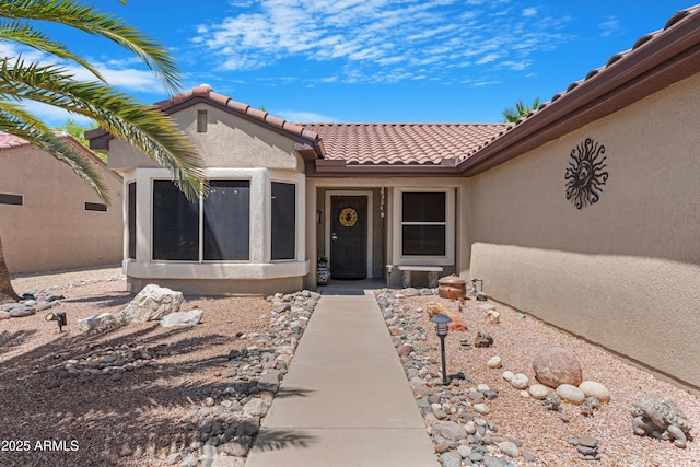 15971 W Indigo Ln, Surprise, AZ 85374 - doorway to property featuring a tile roof and stucco siding