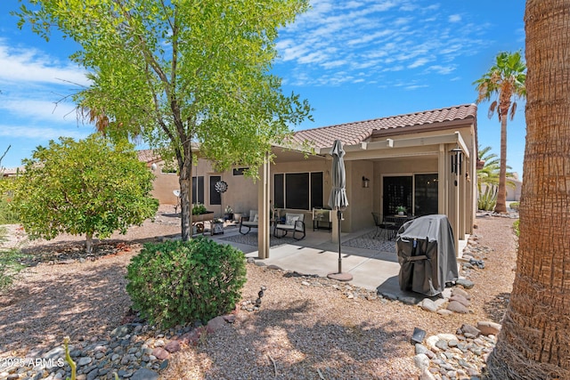 15971 W Indigo Ln, Surprise, AZ 85374 - back of house featuring a tile roof, stucco siding, and a patio area