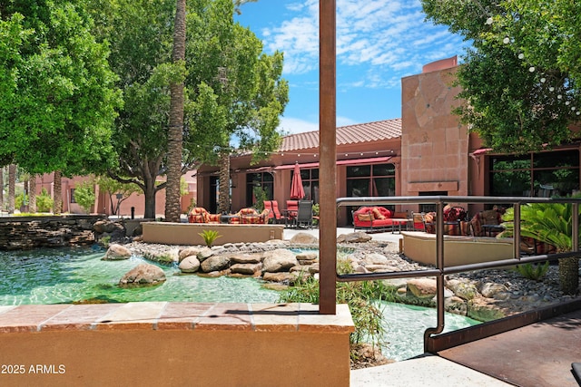 15971 W Indigo Ln, Surprise, AZ 85374 - view of swimming pool featuring an outdoor hangout area, a garden pond, and a patio