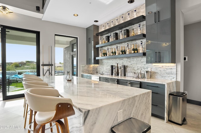 3282 E Palo Verde Dr, Paradise Valley, AZ 85253 - bar with light tile patterned floors, gray cabinetry, light stone counters, and tasteful backsplash