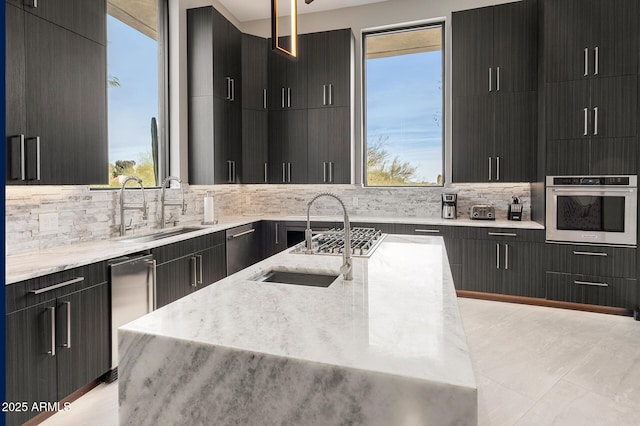 3282 E Palo Verde Dr, Paradise Valley, AZ 85253 - kitchen with a healthy amount of sunlight, sink, a center island with sink, and oven