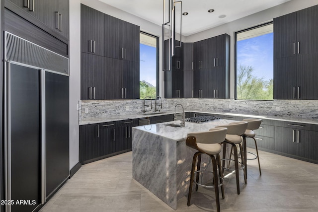 3282 E Palo Verde Dr, Paradise Valley, AZ 85253 - kitchen with pendant lighting, a kitchen bar, paneled built in fridge, an island with sink, and plenty of natural light