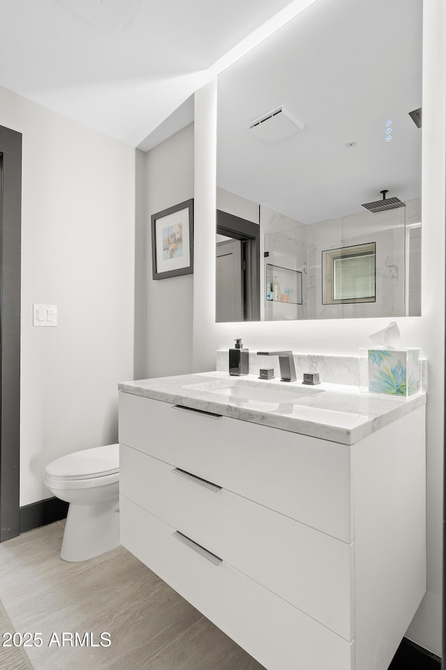 3282 E Palo Verde Dr, Paradise Valley, AZ 85253 - bathroom with hardwood / wood-style flooring, an enclosed shower, vanity, and toilet
