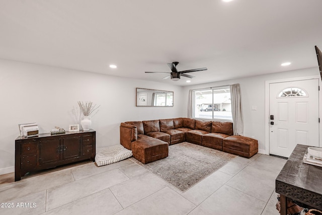 living area featuring light tile patterned floors, baseboards, a ceiling fan, and recessed lighting