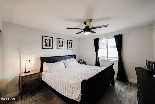 bedroom featuring baseboards, dark carpet, and a ceiling fan