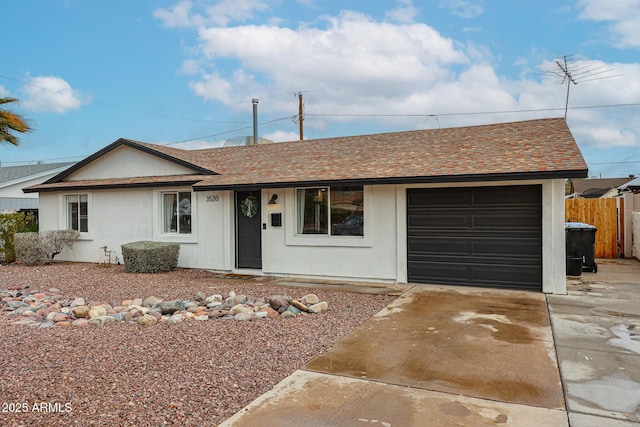 ranch-style house with a garage, fence, concrete driveway, roof with shingles, and stucco siding