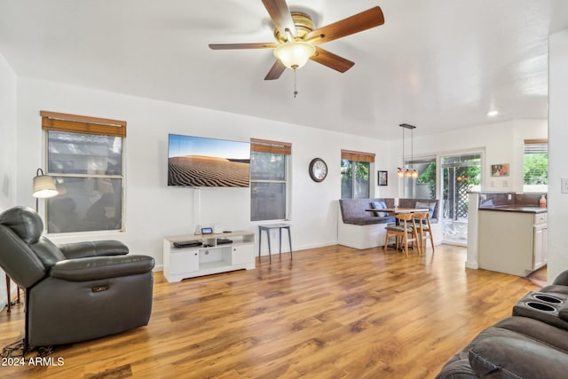 living room with ceiling fan and light hardwood / wood-style flooring