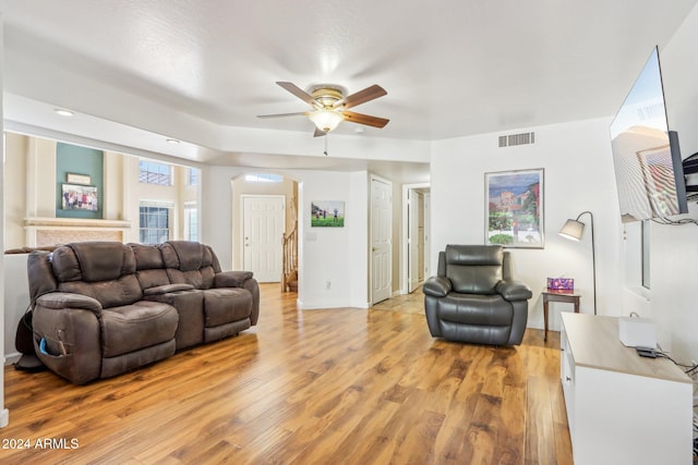 living room with ceiling fan and light hardwood / wood-style flooring