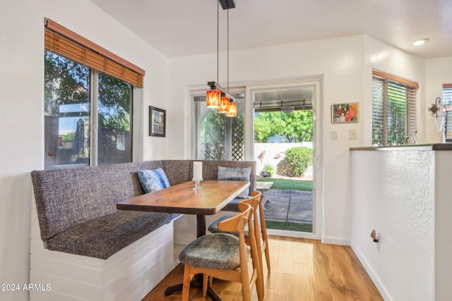 dining space with breakfast area and light hardwood / wood-style floors