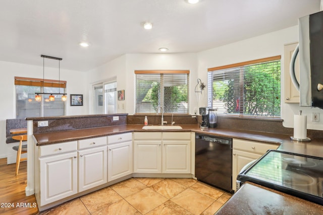 kitchen with sink, light tile patterned floors, hanging light fixtures, and black dishwasher