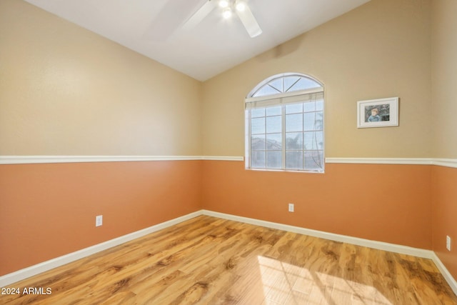 spare room with ceiling fan, wood-type flooring, and lofted ceiling