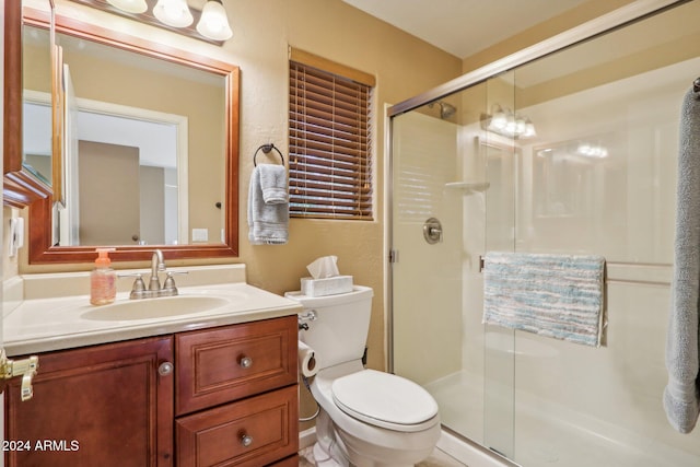 bathroom with vanity, toilet, and an enclosed shower