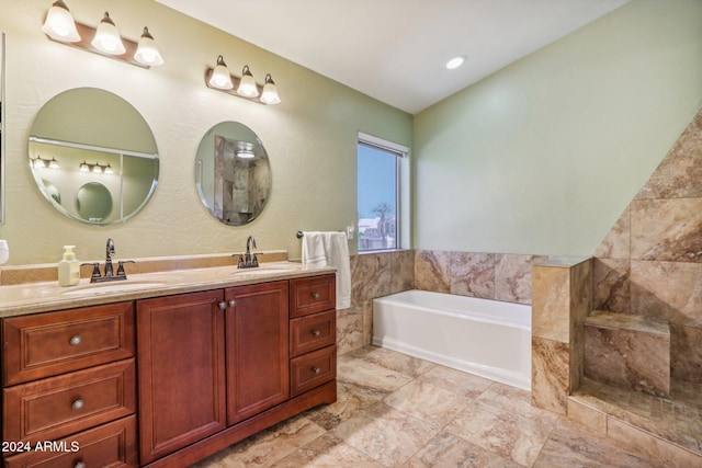 bathroom with a tub to relax in and vanity