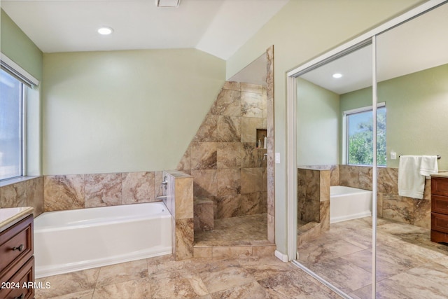 bathroom featuring plus walk in shower, vanity, and lofted ceiling