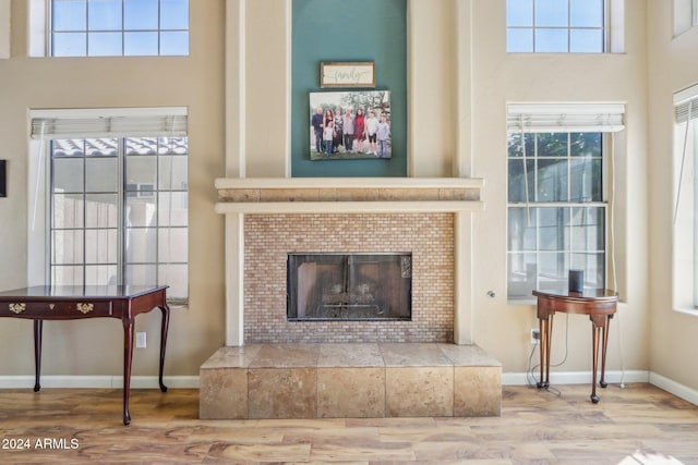 living area featuring hardwood / wood-style floors and a tiled fireplace